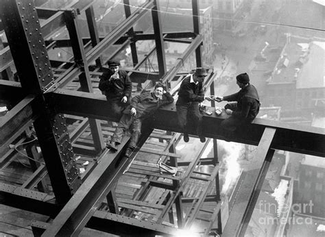 Workers eating on a steel beam